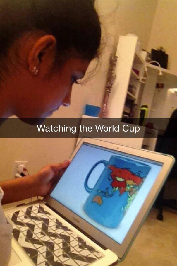 Woman humorously watching a World Cup mug on her laptop; a hilarious Snapchat moment.