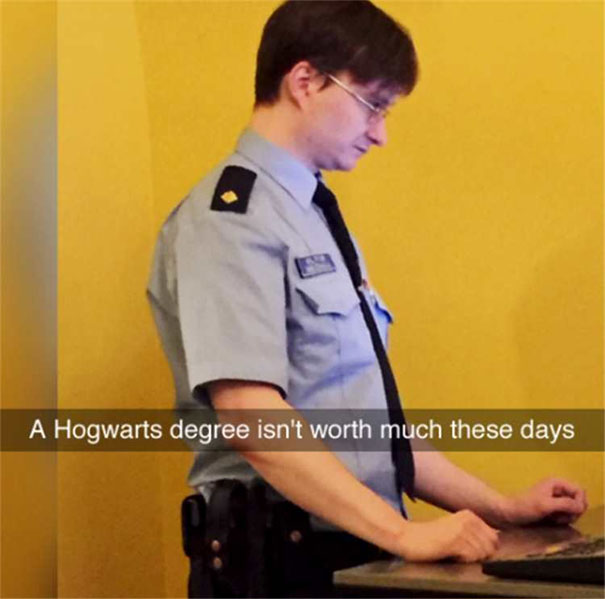 A man in uniform working at a computer with a funny Snapchat caption about a Hogwarts degree.