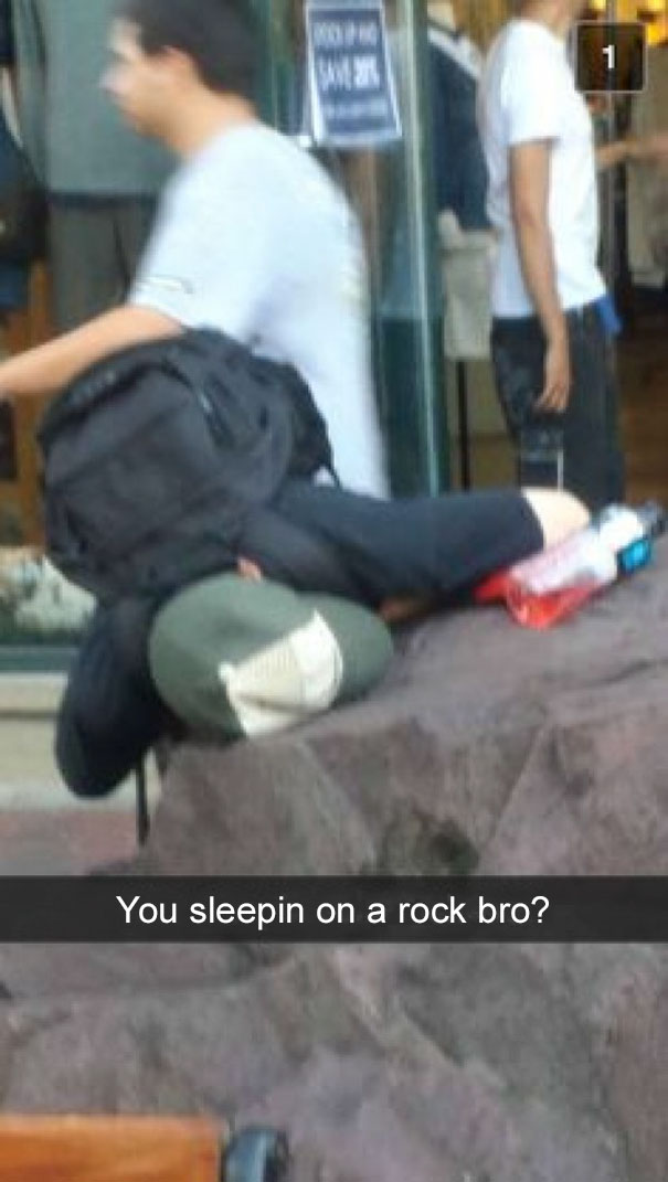 Person napping on a rock with a backpack, featuring a humorous Snapchat caption.