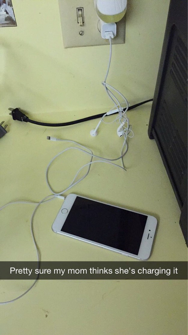 Funny Snapchat of an uncharged iPhone with earbuds plugged into a wall socket.