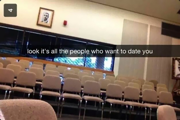 Empty auditorium with Snapchat caption humorously implying no one is interested in dating, reflecting hilarious Snapchats.