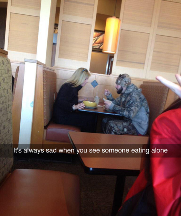 Two people eating together at a restaurant booth; funny Snapchat caption overlay adds humor.