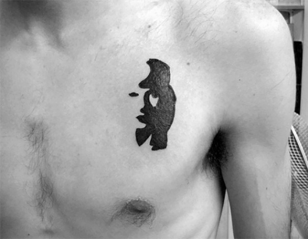 Tattoo of abstract shape with hidden meaning on a person's chest.