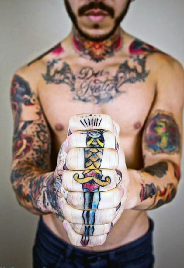 Man with clever tattoos, including a dagger design on his knuckles, symbolizing hidden meaning.