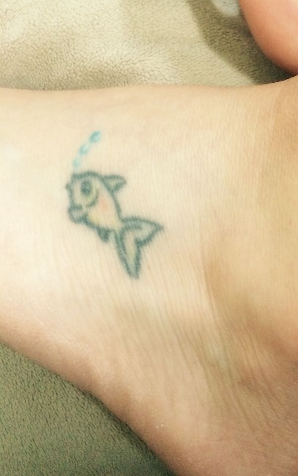 Small fish tattoo on foot showcasing minimalist tattoo ideas.