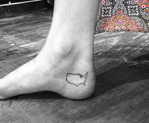 Small foot tattoo of the USA map on the ankle showcases minimalistic design.