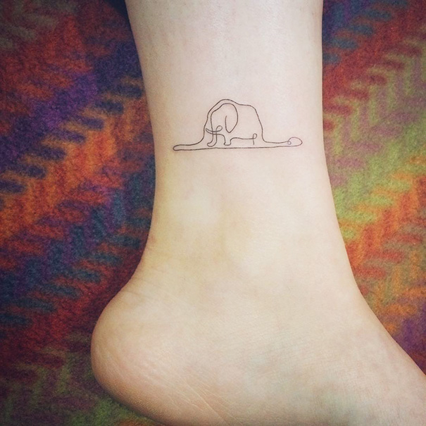 Minimalist elephant tattoo on ankle, showcasing small foot tattoo idea emphasizing simplicity and elegance.