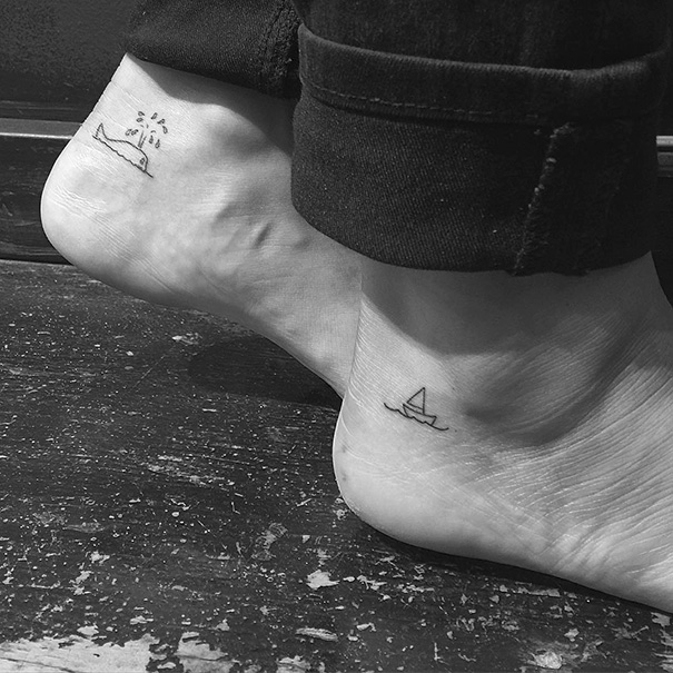 Minimalist small foot tattoos featuring a whale and a sailboat.