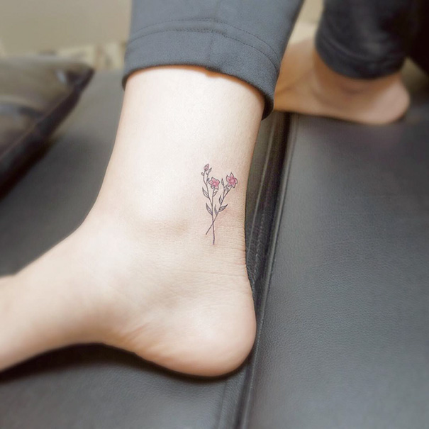 Minimalist flower tattoo on a foot, showcasing small foot tattoo ideas with delicate details.