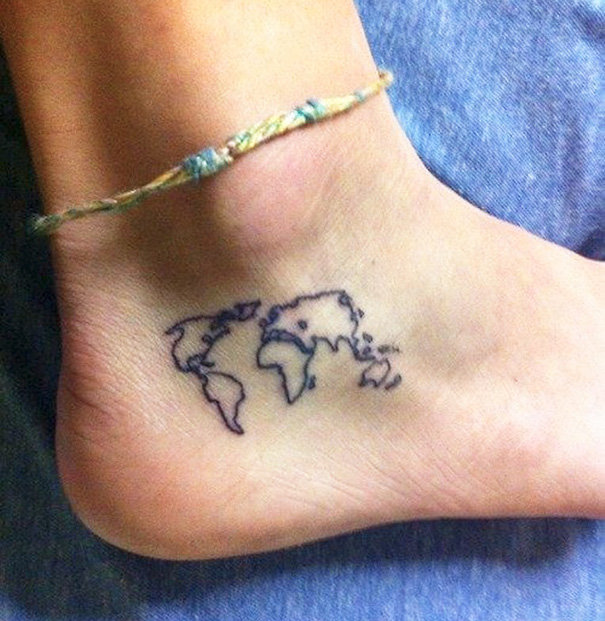 Small foot tattoo of a world map outline, highlighting minimalist design.