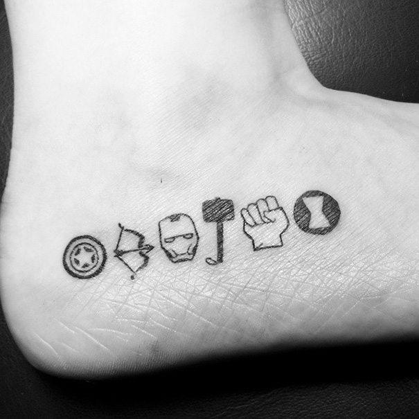 Minimalist Avengers-themed small foot tattoos showcasing less is more.