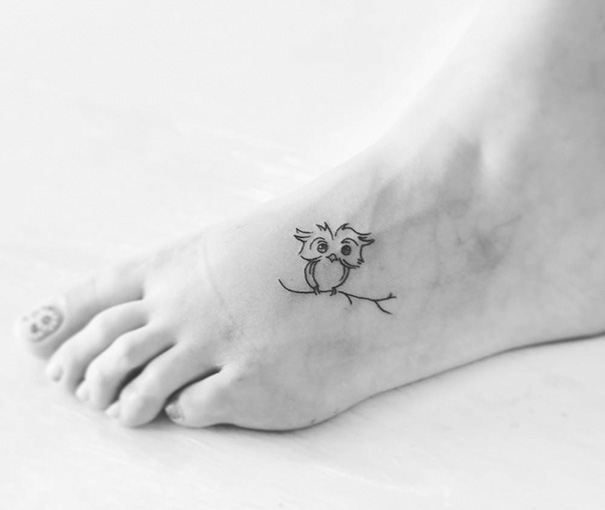 Small foot tattoo with a simple owl design, showcasing minimalist style.