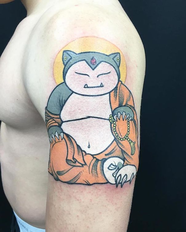 Snorlax tattoo in Buddhist monk attire on arm, blending Pokémon and spiritual themes.