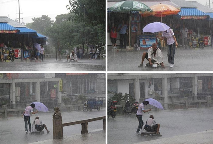 Woman Covering A Soaked Man With Her Umbrella