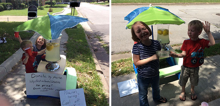 Kids selling lemonade to Pokemon Go players on a sidewalk, using a colorful stand with an umbrella, enjoying the Pokemon Go craze.