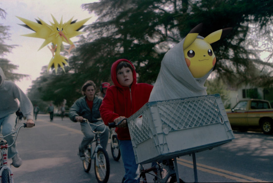 Pikachu in a bicycle basket with kids, recreating a classic movie scene, while Zapdos flies above.