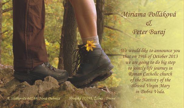 Couple standing on rocks in hiking boots with flower detail, showcasing creative wedding invitations in a natural outdoor setting.
