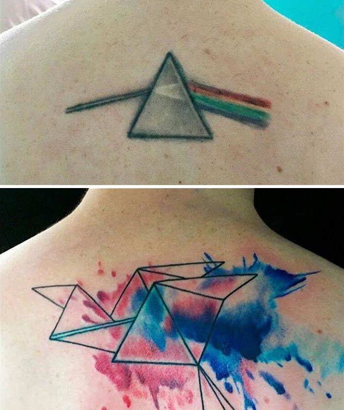 Geometric cover-up tattoo with colorful abstract splashes over an old triangle design.