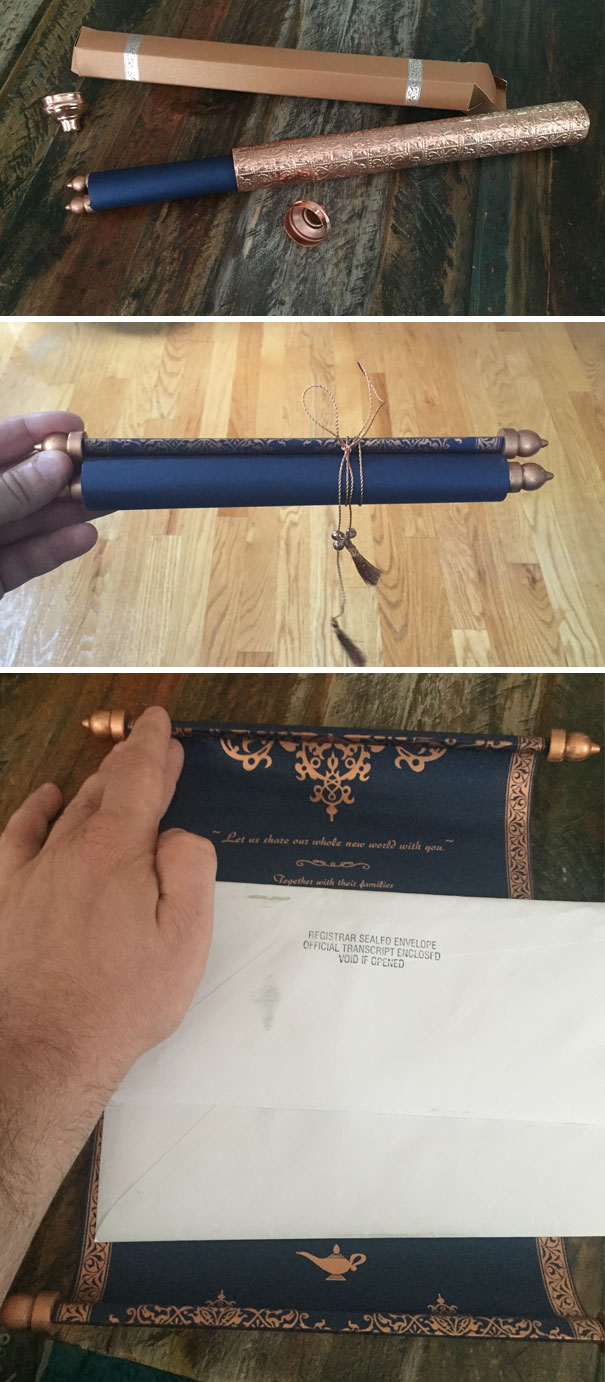 Roll-style creative wedding invitation in navy blue and bronze, featuring intricate details and a tied tassel string closure.