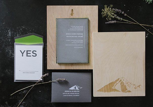 Creative wedding invitations with modern typography, natural wood details, and minimalistic mountain-themed design elements.