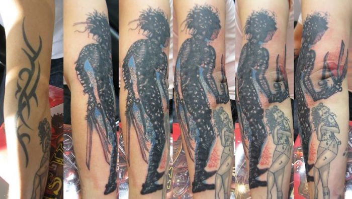 Cover-up tattoo transformation from tribal design to silhouette art with intricate details.