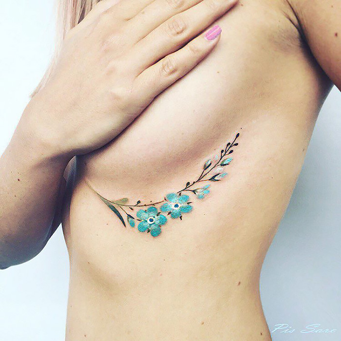 Delicate floral tattoo on the side, inspired by changing seasons.