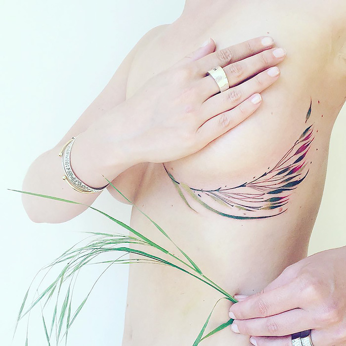 Delicate nature tattoo with leaf motifs, adorned on bare skin, inspired by changing seasons.