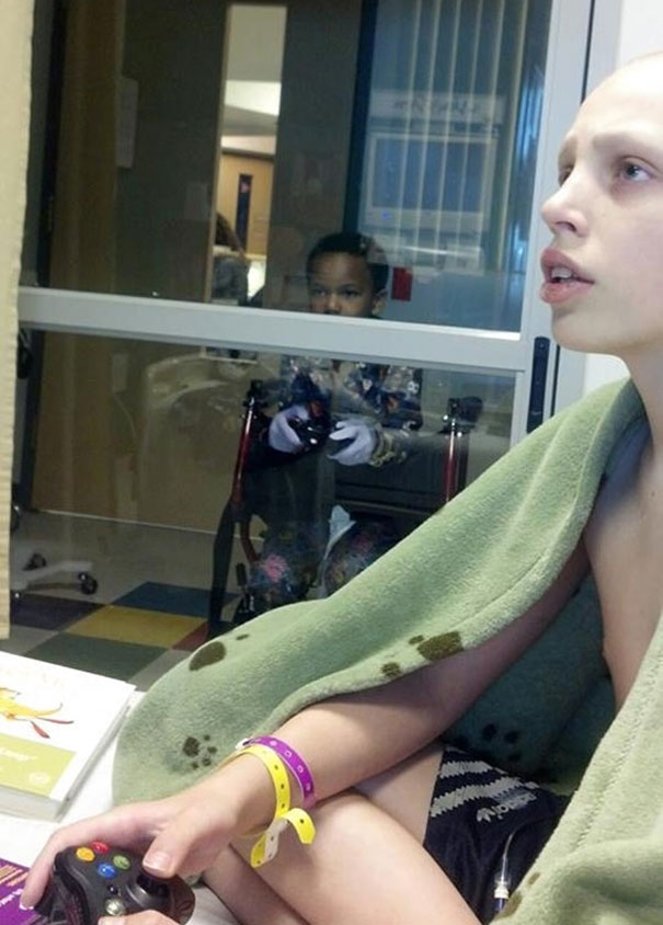 Little Boy Plays Video Games With His Friend Who's Stuck In Quarantine At The Hospital