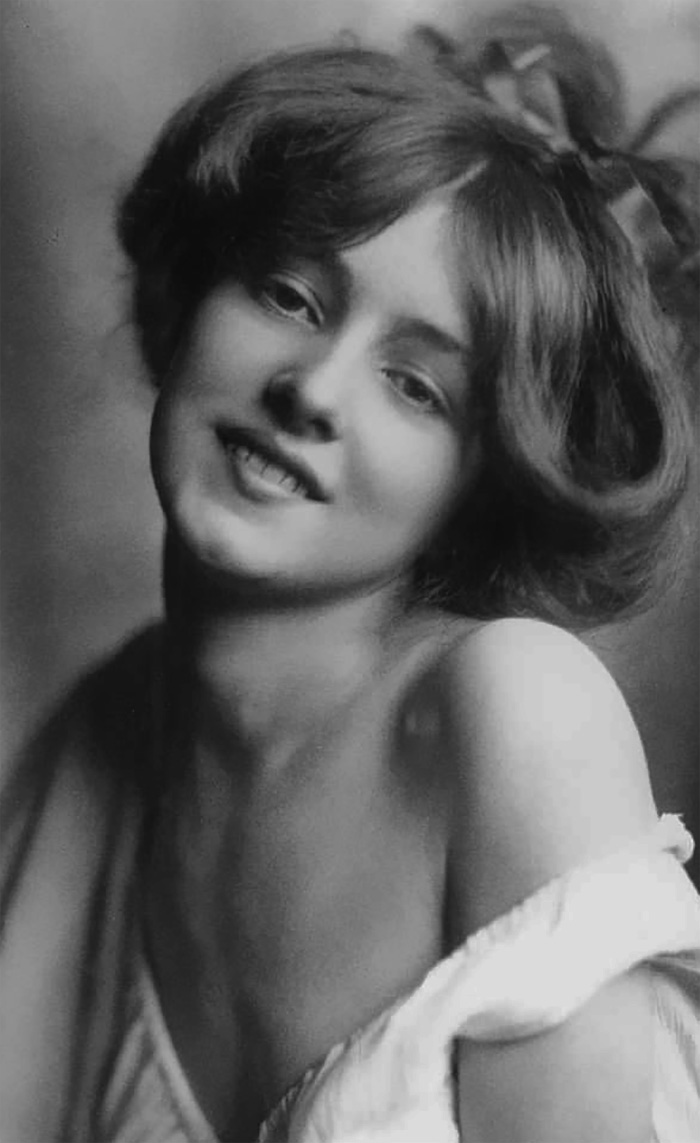 Edwardian era woman smiling, showcasing early 1900s beauty with natural elegance and vintage hairstyle.