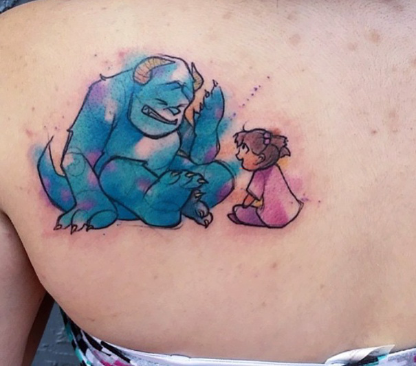 Pixar-inspired tattoo featuring a blue monster and a child in a playful scene on a person's back.
