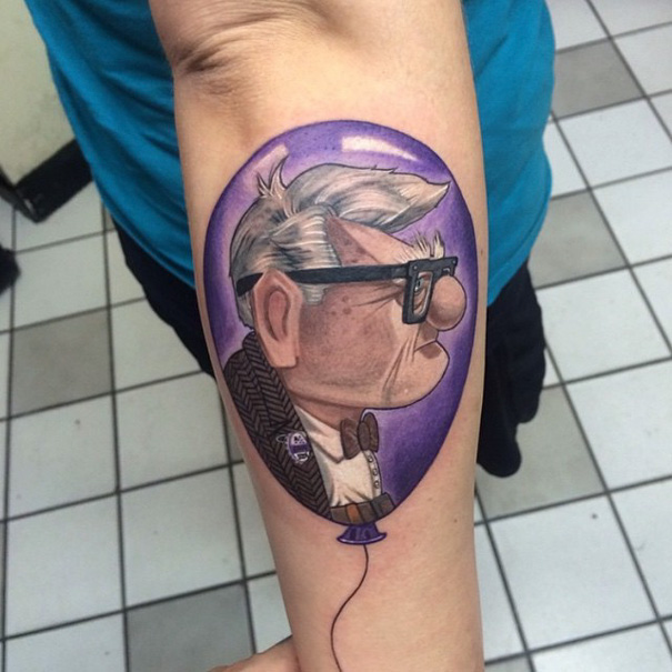 Pixar tattoo of a character inside a purple balloon on forearm.
