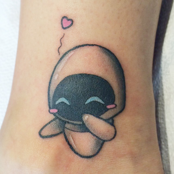 Cute Pixar-inspired tattoo of a blushing character with a heart above its head.