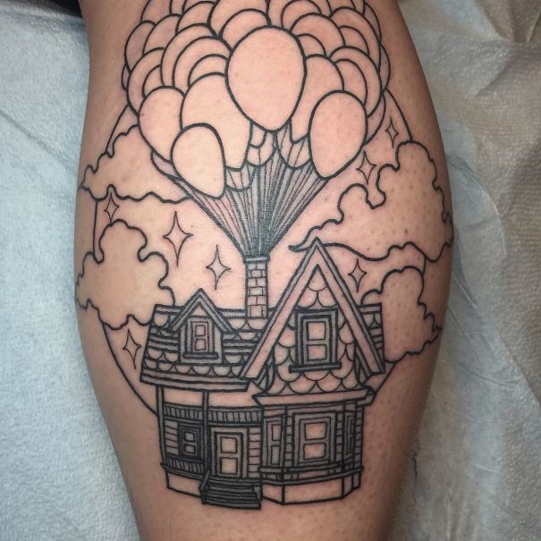 Pixar-inspired tattoo of a house with balloons, reminiscent of the movie "Up," inked on skin.
