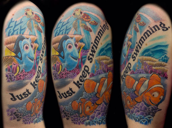 Pixar tattoo featuring colorful fish and coral with the phrase "Just keep swimming."