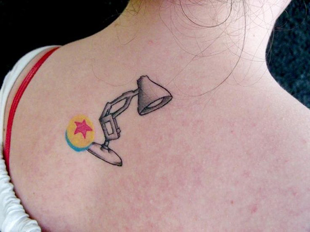 Pixar-inspired tattoo featuring the iconic lamp and ball on a person's back.