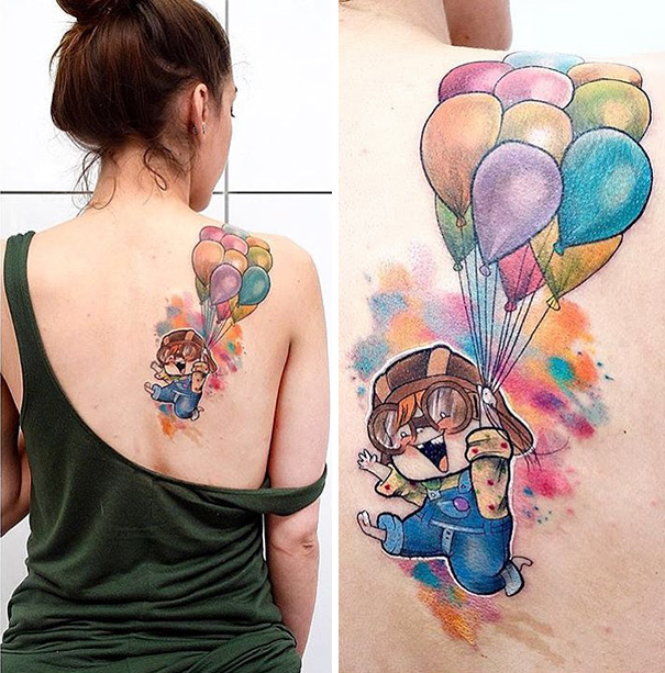 Woman with a colorful Pixar-inspired tattoo featuring a character holding balloons on her back.