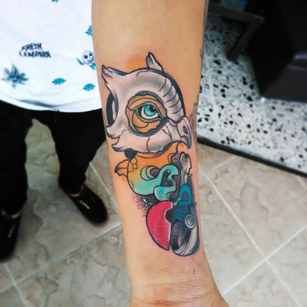 Colorful Pokemon tattoo design on forearm featuring Cubone with bright, vibrant elements perfect for fans.