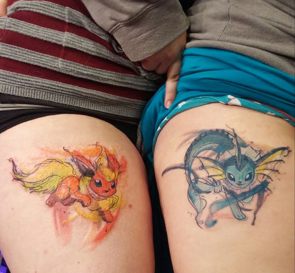 Two colorful Pokemon tattoos featuring Flareon and Vaporeon on thighs.