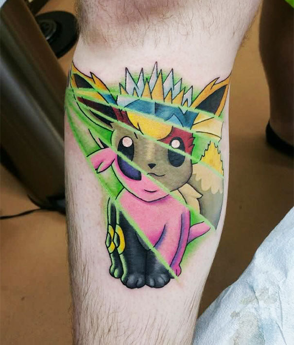 Colorful geometric Pokemon tattoo on a person's leg.