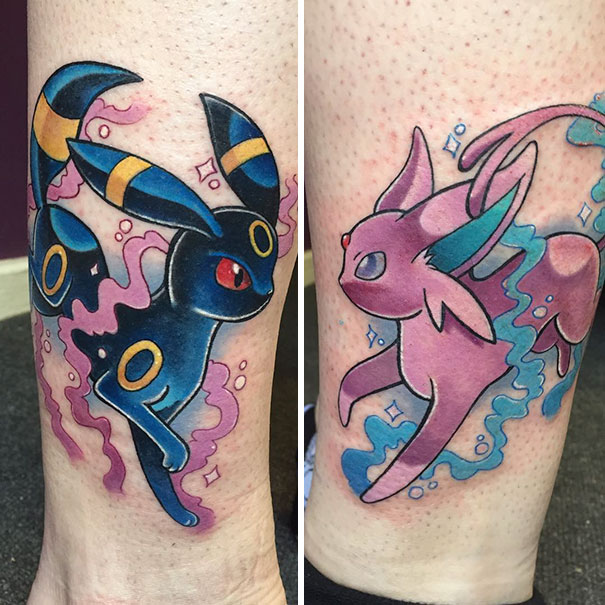 Colorful Pokemon tattoos of Umbreon and Espeon on forearm, showcasing vibrant designs for Pokemon fans.