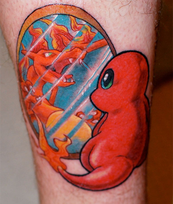 Pokemon tattoo featuring Charmander looking at Charizard in a mirror, capturing vibrant colors and dynamic design.