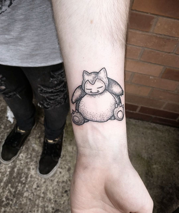 Snorlax tattoo on a forearm, showcasing Pokemon-themed body art.