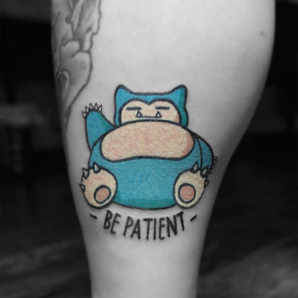Snorlax tattoo with "Be Patient" text on a person's leg, perfect for Pokémon fans.