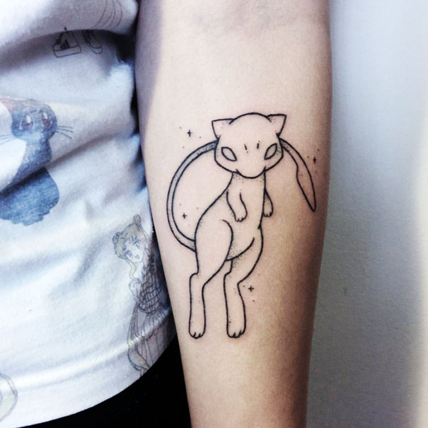 Pokemon tattoo of Mew on forearm with simple line art design.