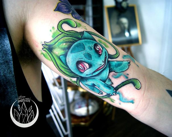 Bulbasaur tattoo art on forearm, showcasing vibrant colors and intricate design, appealing to Pokemon fans.