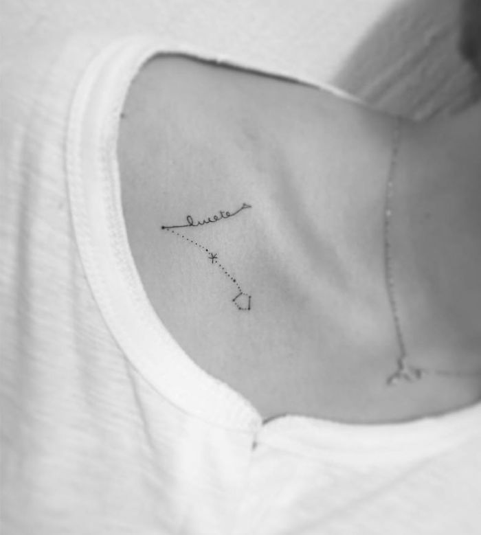 Minimalist tattoo on a person's chest, featuring a delicate constellation design by a Korean artist.