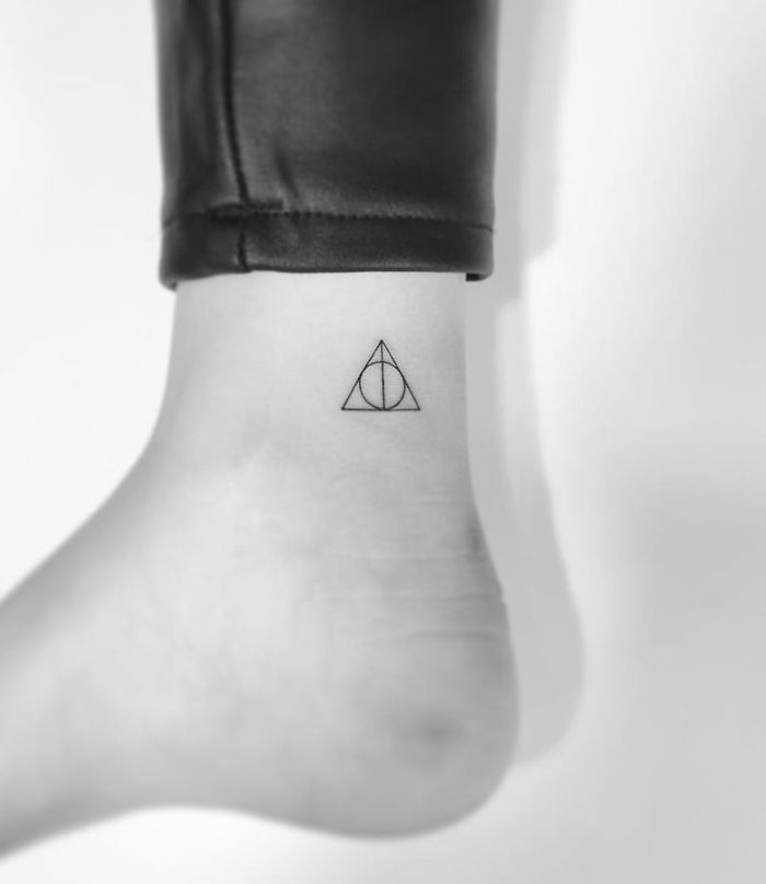 Minimalist tattoo by Korean artist on ankle: simple geometric design.