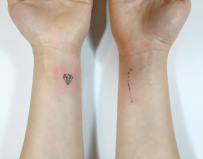 Minimalist tattoos by a Korean artist featuring a diamond and constellation on wrists.