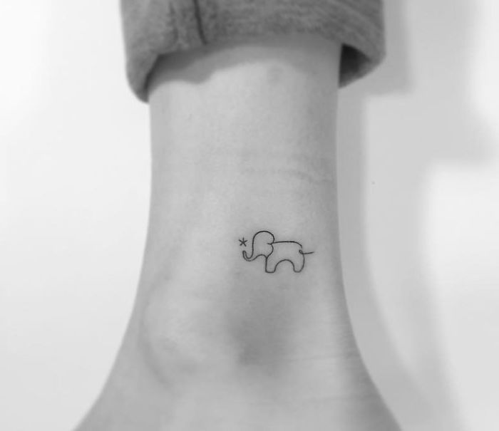 Minimalist elephant tattoo on an ankle, designed by a Korean artist.