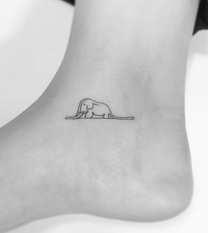Minimalist tattoo of a simple elephant on an ankle, designed by a Korean artist.